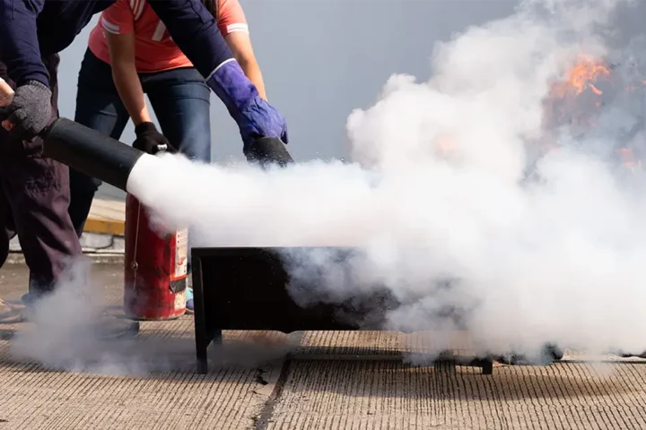 women learning how to use fire extinguisher