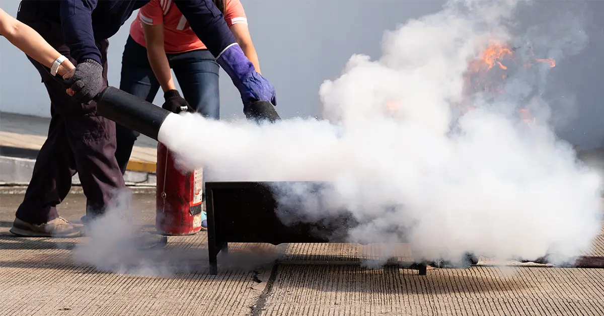 women learning how to use fire extinguisher