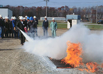 workers training with fire extinguisher