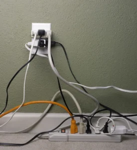 electrical outlet with a dozen of random cords plugged in