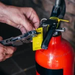 inspection tag on fire extinguisher being marked