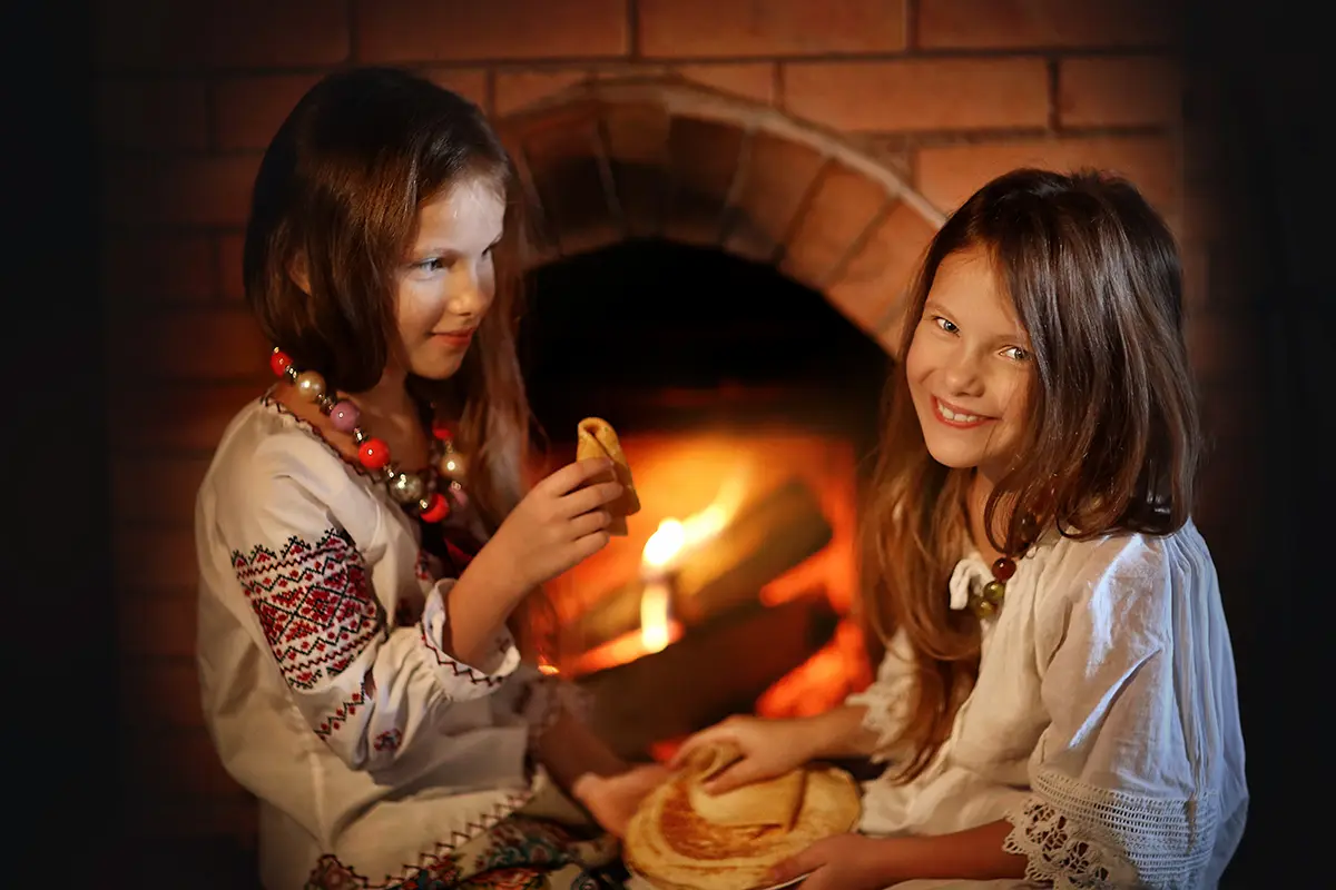 girls eating in front of fireplace